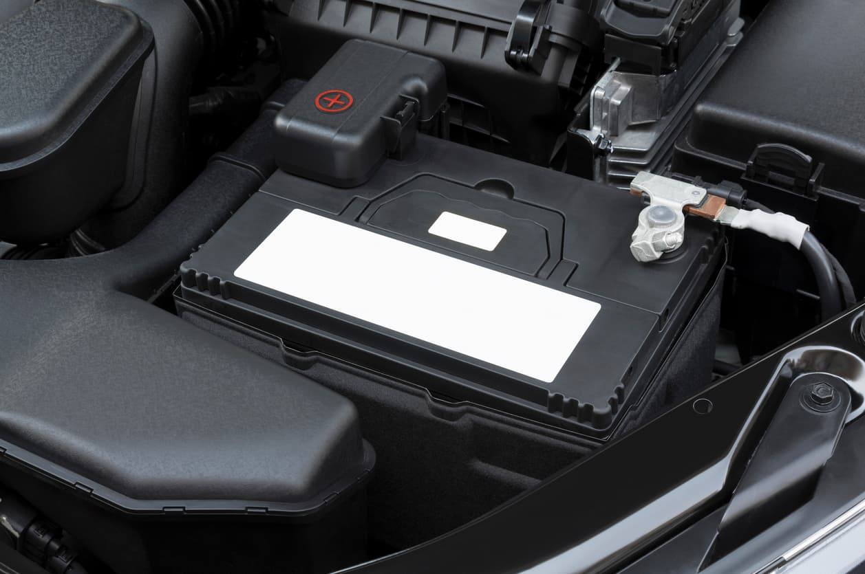 Mechanic testing car battery