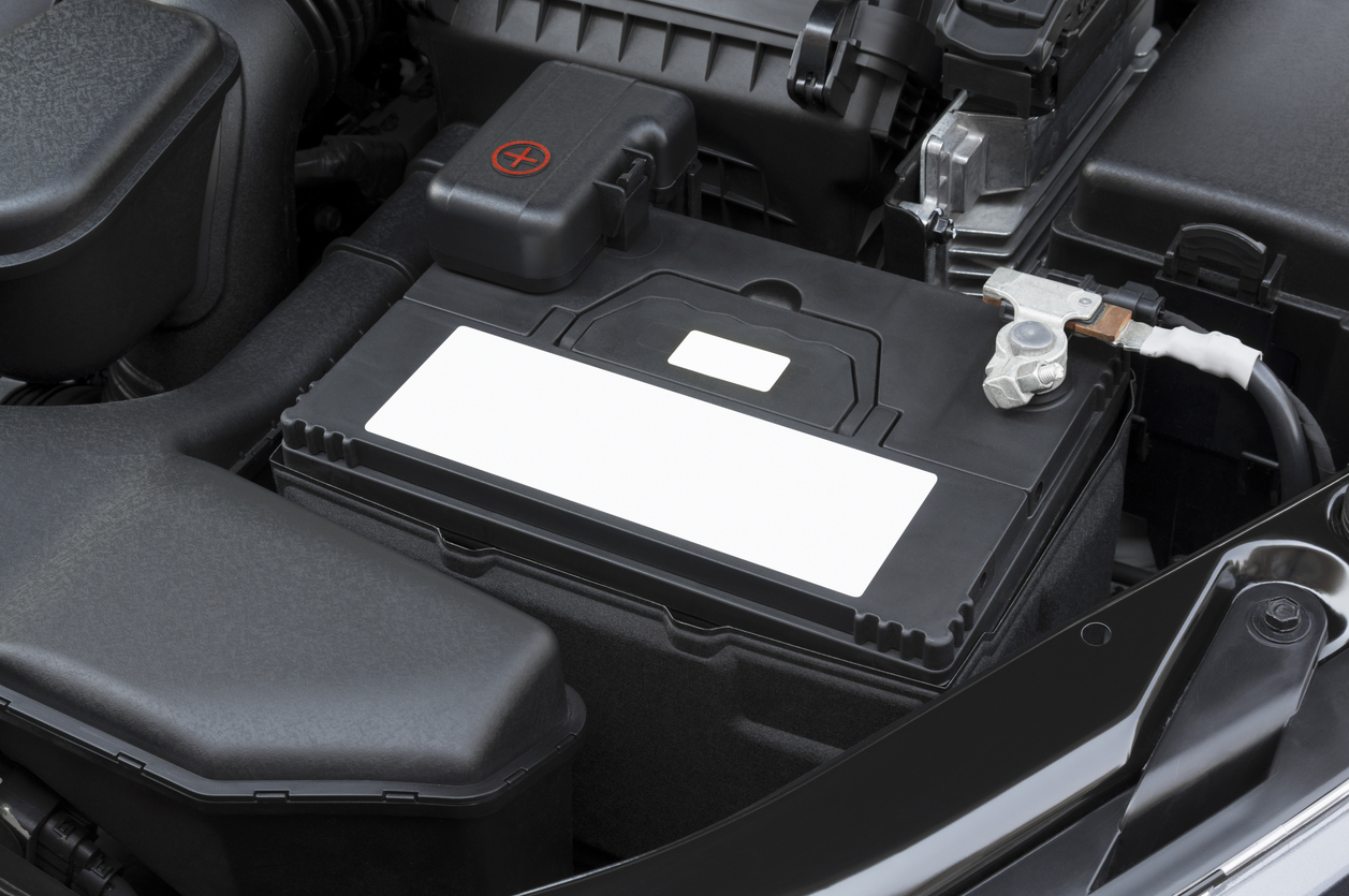 Mechanic testing car battery